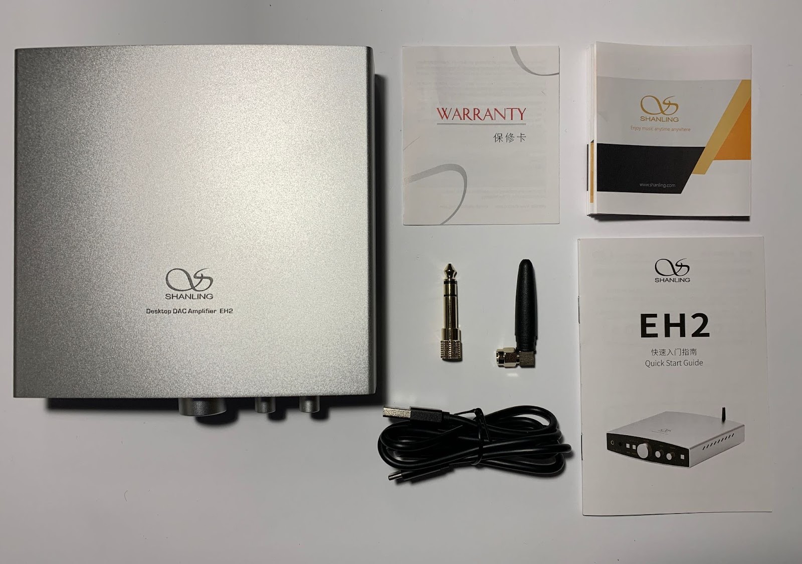 Shanling EH2 comes in a small square box, weighing about 1 kg. The box is made of ordinary, as it is fashionable to say now, “kraft” cardboard. On it we see a contour image of the device from the top in the center, the company logo is present at the top, and the name of the model and device at the bottom. 