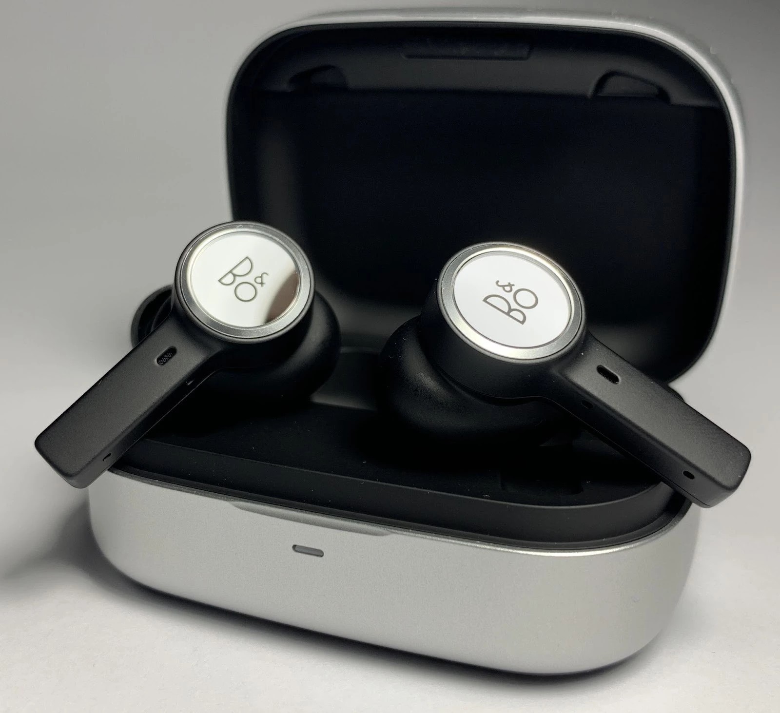 The headphones look expensive and minimalistic: a case made of high-quality soft-touch plastic, glass faceplates with touch control and metal accents. 