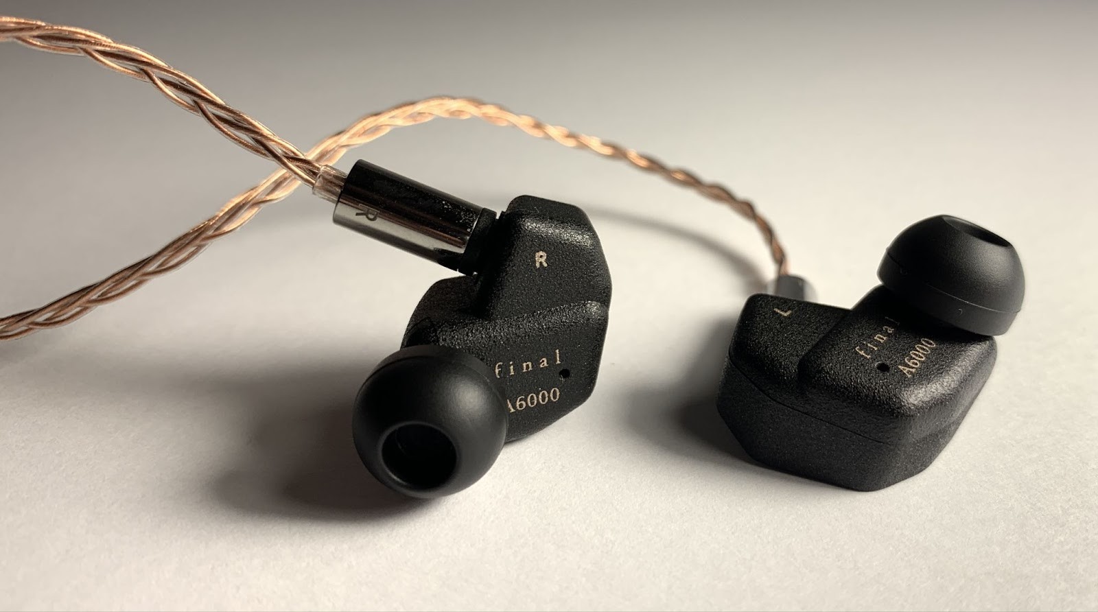 The ear pads are quite tightly fixed to the headphone body - they are not easy to put on, but they definitely will not fall off on their own.