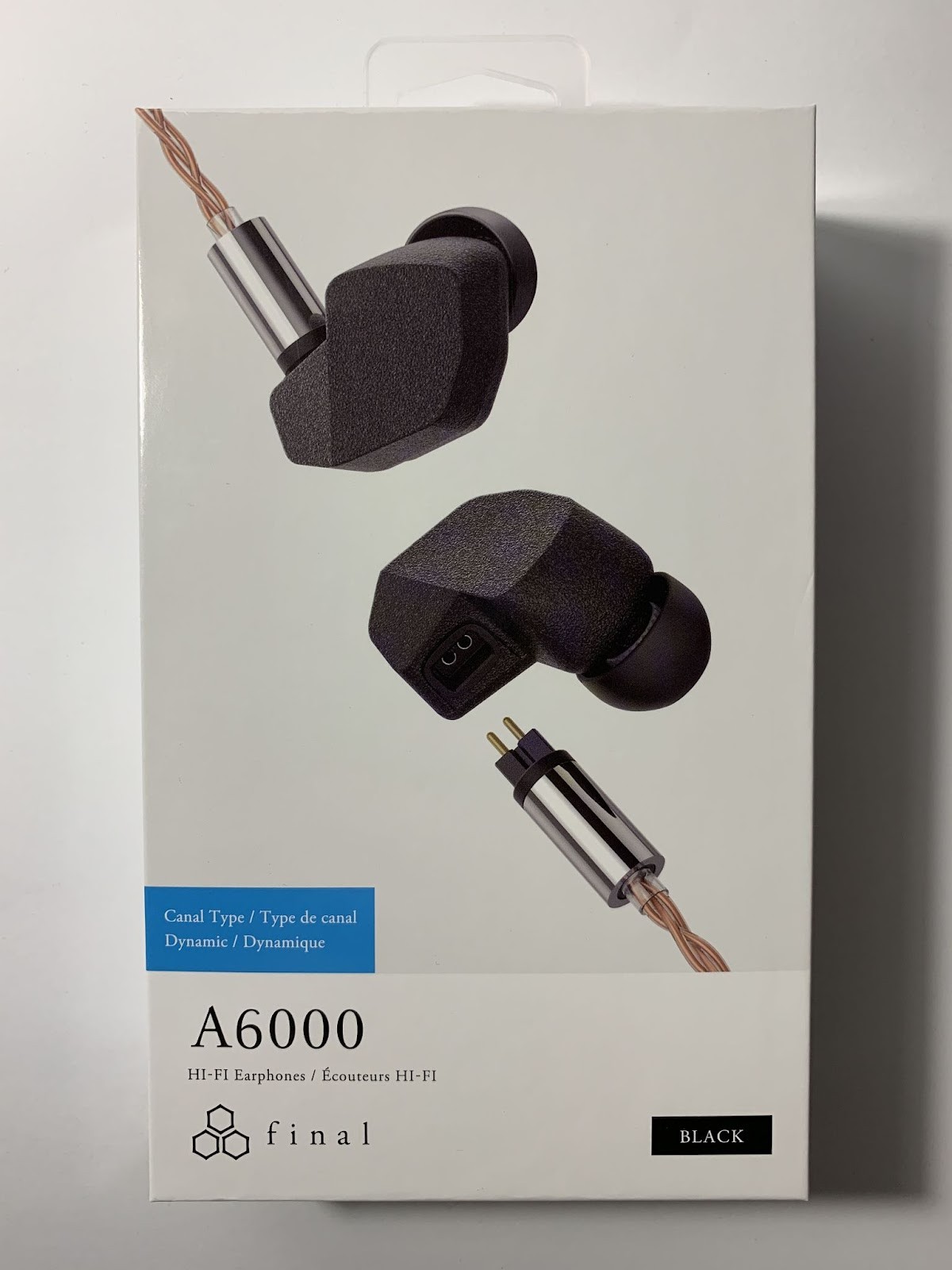 The Final Audio A6000 headphones come in a small, elongated white box made of medium-stiff cardboard. 