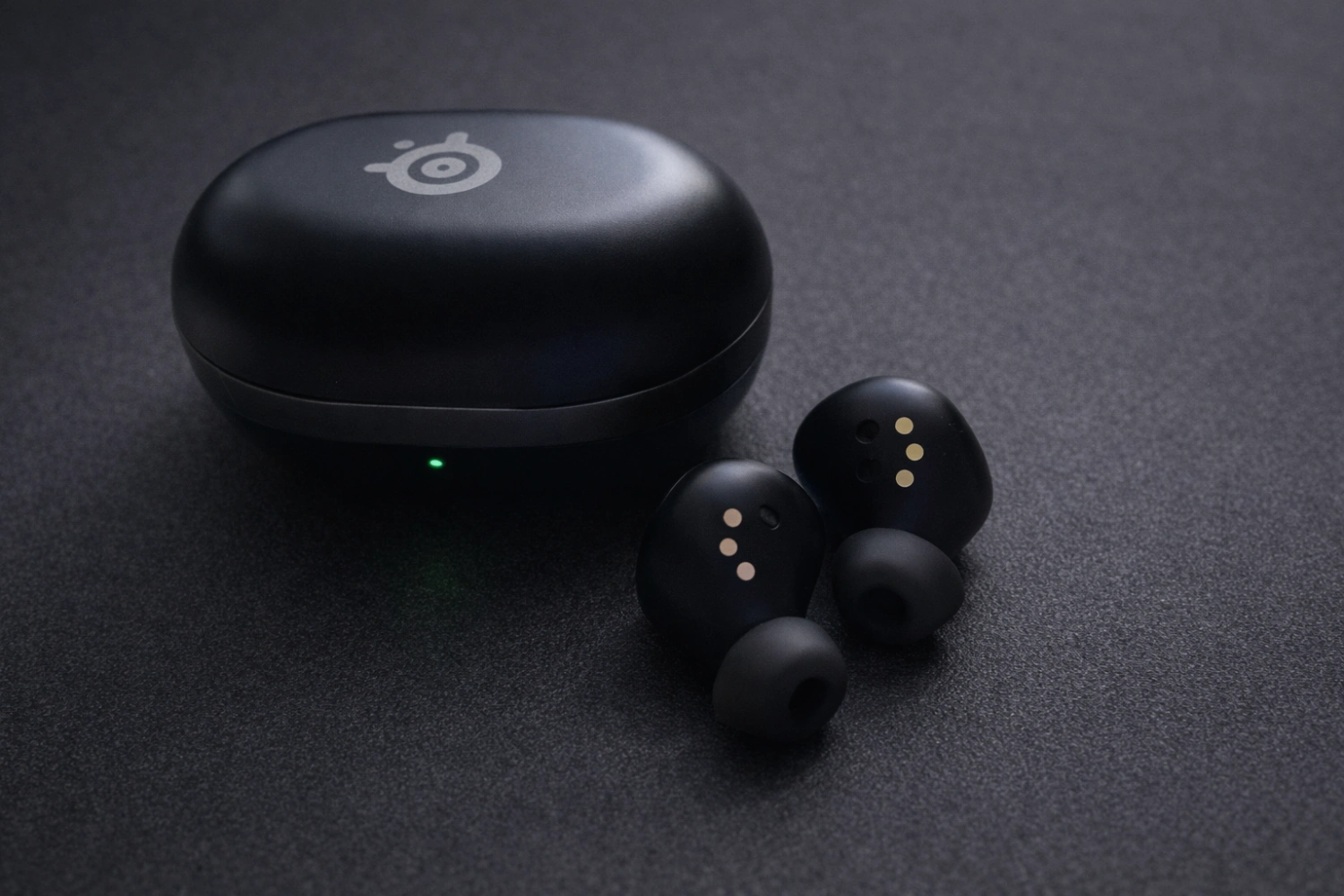 The compact charging case doubles as storage for the wireless dongle, making the GameBuds a practical travel companion.