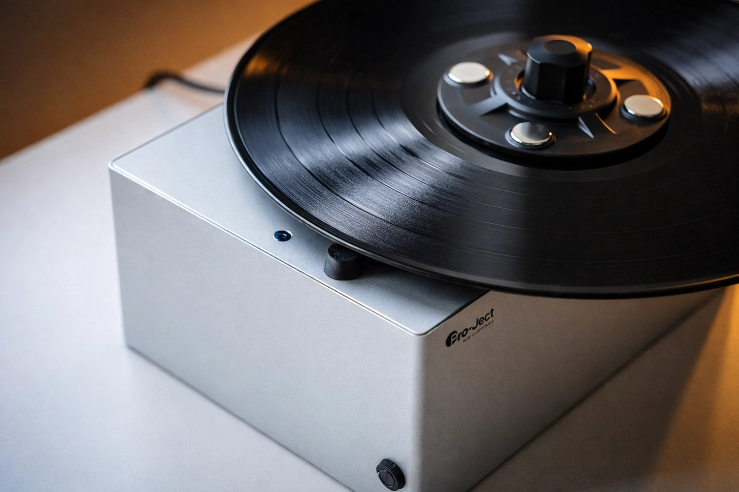 The Pro-Ject VC-E Mini is a space-saving vinyl record cleaner with innovative bottom vacuum design, low noise operation, and effective dust and residue removal, ideal for keeping your records in top condition.