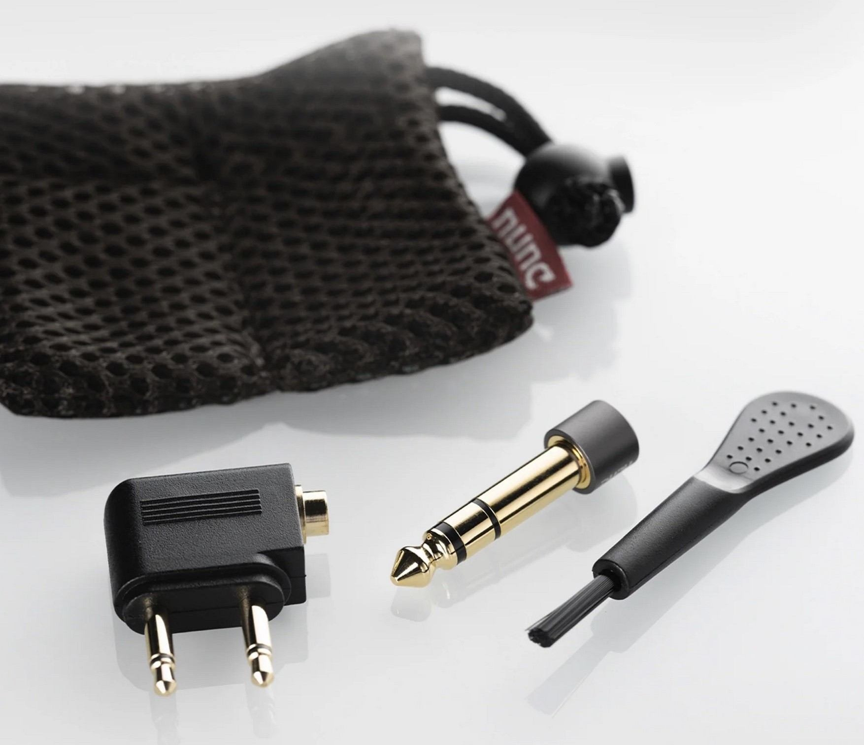 The package includes a FitEar 013 cable with a proprietary FitEar two-prong connector and an Oyaide 3.5mm plug. A set of ear tips, a protective Pelican 1010 case, and additional accessories for storage and maintenance are also included.